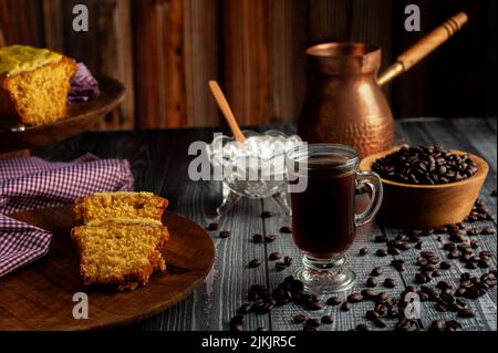 A closeup shot of a table full of cake slices, cup of coffee, coffee beans on a blue table Stock Photo