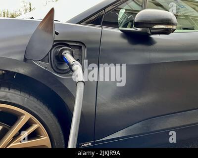 Black Jaguar electric car charging Stock Photo