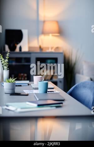 Vertical background image of modern home interior with workplace in dark blue colors Stock Photo
