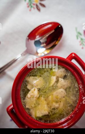 A Top view of a chicken soup on a red bowl Stock Photo