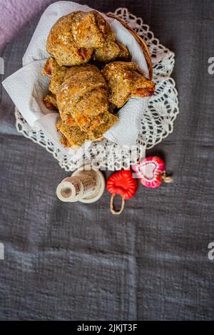 A top view of plates of croissants on a macrame designed tablecloth Stock Photo