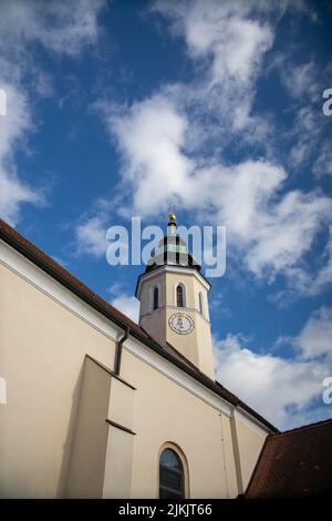 A vertical low angle shot of Saints Peter and Paul church tower in Gerasdorf bei Wien, Austria Stock Photo