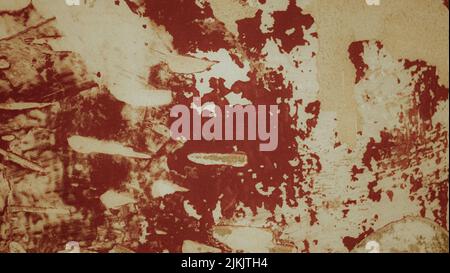 Old weathered painted wall background texture. Red dirty peeled plaster wall with falling off flakes of paint Stock Photo