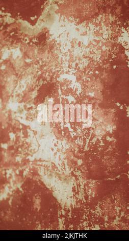 Old weathered painted wall background texture. Red dirty peeled plaster wall with falling off flakes of paint Stock Photo