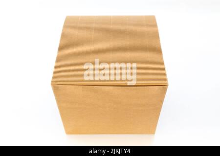 A square corrugated kraft cardboard box isolated on white background. Stock Photo