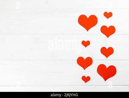 red hearts on a white wooden background frame Stock Photo