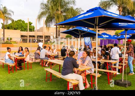 Johannesburg, South Africa - September 11, 2015: Diverse young people at outdoor beer garden Stock Photo