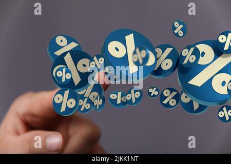 A closeup shot of male touching floating sales icons in the air Stock Photo