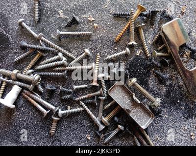 A closeup of rusty screws on the ground Stock Photo