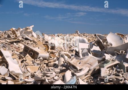 Broken toilets and other bathroom fixtures intended for recycling into paving asphalt at the Miramar landfill in San Diego, California Stock Photo