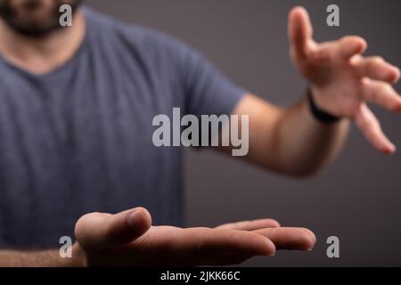 A closeup of a male showing an outstretched hand with an open palm Stock Photo