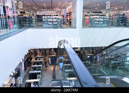 Moscow, Russia, June 2019: Inside the HM store - view from the escalator to the first floor with clothes. second floor with children's clothing Stock Photo