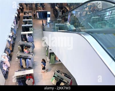 Moscow, Russia, June 2019: View from the second floor to the first inside the store HM clothes, buyers and escalator. Stock Photo