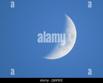A close-up view of the first quarter moon in the daytime. Stock Photo