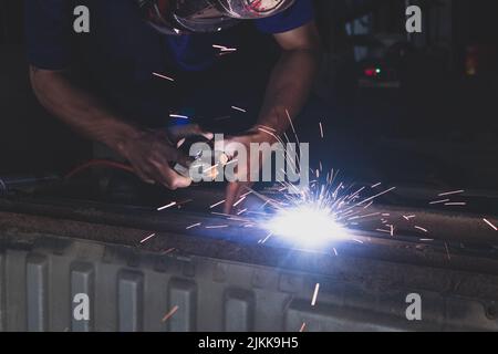 A welder welding automotive part in a car factory Stock Photo