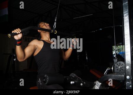 An attractive muscular man exercising in a gym Stock Photo
