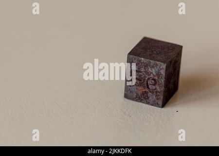 Iron cube with element name Fe on it on cream background Stock Photo