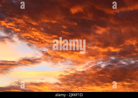 A low angle shot of the reddish sky with clouds during sunset Stock Photo