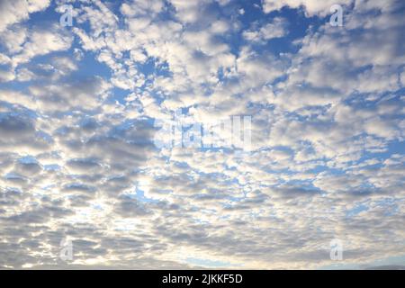 A low angle shot of the blue sky with cumulus clouds Stock Photo
