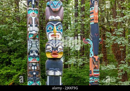 Native indigenous first nations totem poles in Stanley Park of Vancouver, British Columbia, Canada. Stock Photo