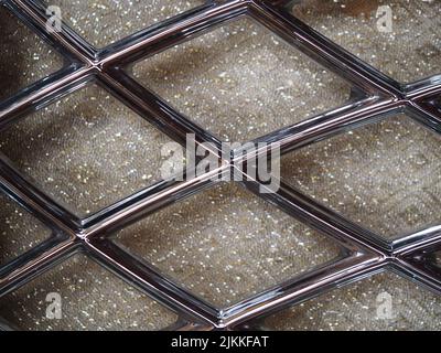 A closeup shot of shiny glass texture with shiny metal pattern for backgrounds Stock Photo