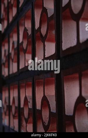 A vertical closeup shot of geometric concrete wall pattern Stock Photo