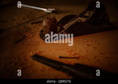 A selective focus shot of a wooden crafting tool in the dark Stock Photo