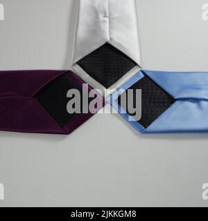 A three multi colored ties on a white background Stock Photo