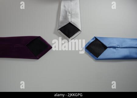 A three multi colored ties on a white background Stock Photo
