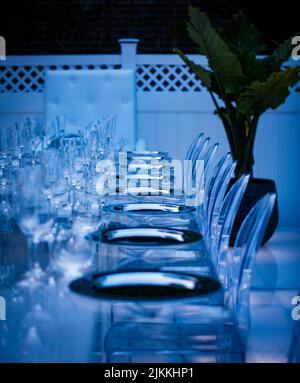 A vertical shot of a beautiful setting of a festive table illuminated in blue on the veranda Stock Photo