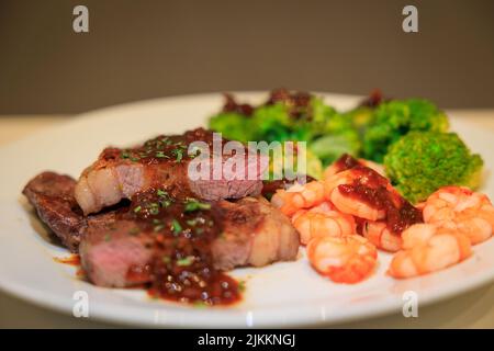A close-up shot of a meal with steak served with sauce and vegetables Stock Photo