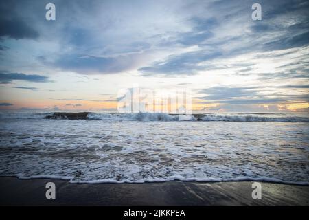 Big waves splashing on the coast captured at sunset in the evening Stock Photo