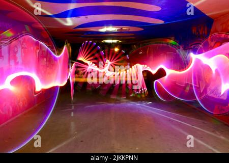 Abstract neon background, liquid neon waves. Futuristic, modern neon. Night screensaver with light effect. Stock Photo
