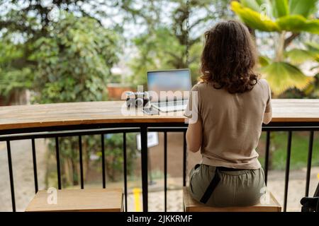 Young woman using laptop while working online Stock Photo