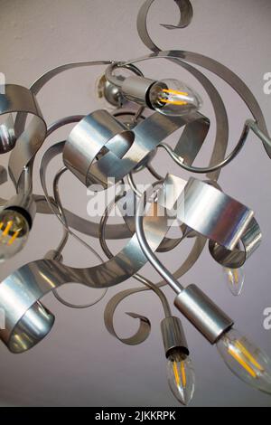 A vertical shot of a silver metal chandelier from a low angle Stock Photo