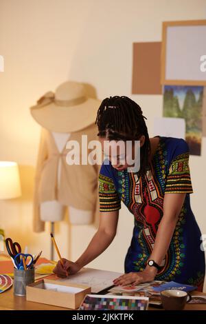 Creative Black woman working on collage for client Stock Photo
