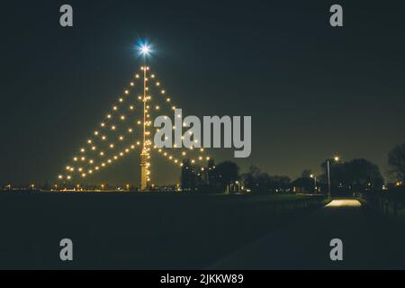 A low angle shot of a Christmas tree decorated with lights Stock Photo