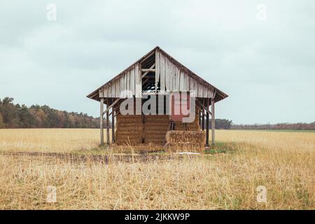 A closeup shot of an abandoned house in the farm on a cloudy day Stock Photo