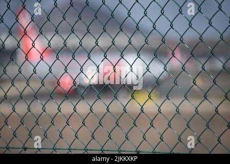 A selective focus of a mesh fence Stock Photo