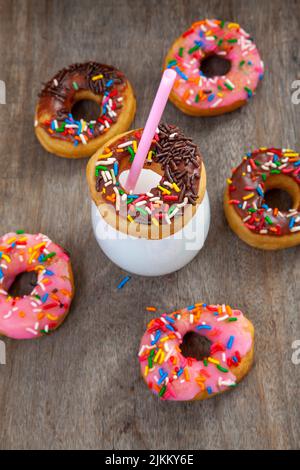 A top view of glass cup of milk with decorated delicious cookies on a table Stock Photo
