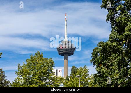 Tall communication tower rising high above Cologne urban skyline Stock Photo