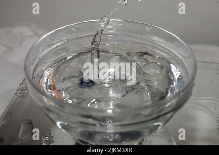 A closeup shot of water splashing in a bowl Stock Photo