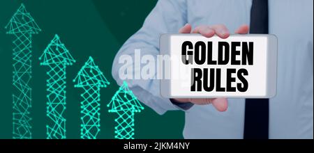 Inspiration showing sign Golden Rules. Business approach Basic principle that should be followed Important Principle Man Showing Tablet By Arrow Stock Photo