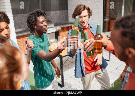 High angle view at diverse group of friends enjoying outdoor party and dancing with beer bottles Stock Photo
