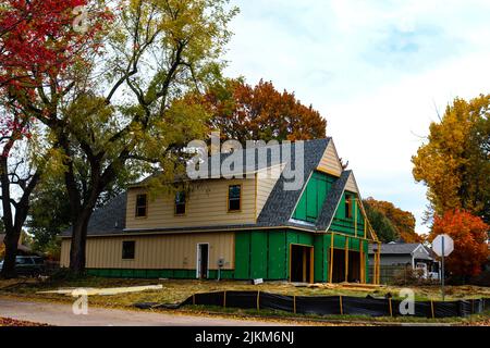 Construction of two story house in leafy neighborhood in Autumn Stock Photo