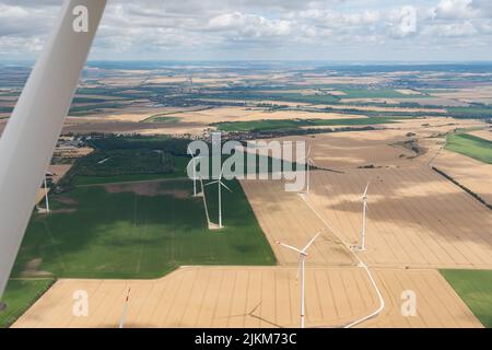 Erfurt, Thuringia, Germany, July 11, 2022 Wind energy stations on a meadow seen from a small plane Stock Photo