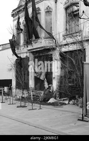 A grayscale vertical shot of a grunge rustic building after fire Stock Photo