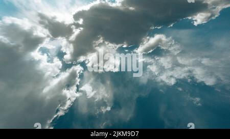 A beautiful view of the sunlight shining through white clouds in the sky Stock Photo