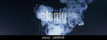 a closeup shot of white smoke on black background Stock Photo