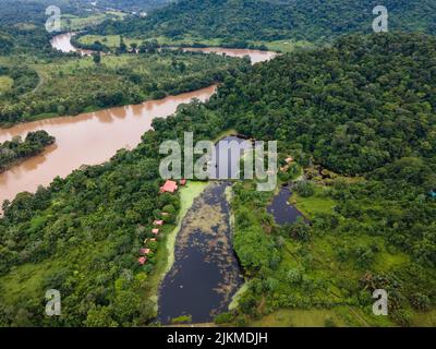 The beautiful aerial view of the river surrounded by green forest. Boca Tapada, Costa Rica. Stock Photo